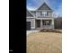 A lovely house with a covered front porch, gray siding, and stylish black garage door at 428 Hampshire Ct, Four Oaks, NC 27524