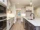 Spacious kitchen showcasing modern appliances, shaker cabinets, an island, and hardwood floors at 428 Hampshire Ct, Four Oaks, NC 27524