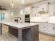 Spacious kitchen featuring a granite island, shaker cabinets, and open layout to living room at 428 Hampshire Ct, Four Oaks, NC 27524