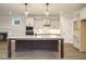 Open kitchen with island, granite countertops, pendant lights, and stainless steel appliances at 428 Hampshire Ct, Four Oaks, NC 27524