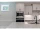 Modern kitchen with shaker cabinets, granite countertops, and stainless steel appliances at 428 Hampshire Ct, Four Oaks, NC 27524