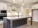Spacious kitchen with white cabinets, granite countertops, stainless steel appliances, and a large center island at 428 Hampshire Ct, Four Oaks, NC 27524