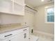 Laundry room features granite counter tops, custom cabinets, and marble tile floors at 428 Hampshire Ct, Four Oaks, NC 27524