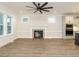 Bright living room featuring hardwood floors, fireplace, and large windows at 428 Hampshire Ct, Four Oaks, NC 27524