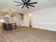 Open living space with a kitchen island, wood floors, and a staircase featuring white railings at 428 Hampshire Ct, Four Oaks, NC 27524