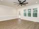 Bright living room featuring a door to a porch, large windows, and white shiplap walls at 428 Hampshire Ct, Four Oaks, NC 27524