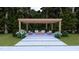 Pergola sitting area with a fire pit, pavers and beautiful shrubs at 4305 Windsor Pl, Raleigh, NC 27609