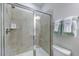 Modern bathroom showcasing a tile and glass enclosed shower with built in shelves and sleek hardware at 615 Contento Ct, Sanford, NC 27330