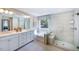 Bright, modern bathroom with double vanity, soaking tub, walk-in shower and plenty of natural light at 615 Contento Ct, Sanford, NC 27330