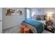 Cozy bedroom with a teal quilt, dog-themed decor, and orange accents at 615 Contento Ct, Sanford, NC 27330