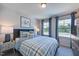 Bedroom with a large window and plaid bedding provides ample light and comfort at 615 Contento Ct, Sanford, NC 27330