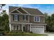 Charming two-story home with attached two-car garage and stone accents at 615 Contento Ct, Sanford, NC 27330