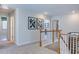 Bright upstairs hallway with carpet and wood railing offers a view of the downstairs at 615 Contento Ct, Sanford, NC 27330