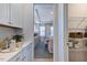 Hallway provides access to a modern dining area, featuring a walk-in pantry with wire shelving at 615 Contento Ct, Sanford, NC 27330