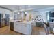 Open concept kitchen with island bar connects to living area with fireplace and stairs to the upper level at 615 Contento Ct, Sanford, NC 27330