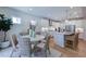 Bright eat-in kitchen features stainless appliances, white cabinets and island with seating, and a dining area at 615 Contento Ct, Sanford, NC 27330