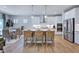 Bright kitchen features a large island with seating, stainless steel appliances, and an adjacent dining area at 615 Contento Ct, Sanford, NC 27330