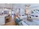 Open-concept living room with white sofas, wood floors, and view to kitchen at 615 Contento Ct, Sanford, NC 27330