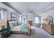 Inviting main bedroom featuring a ceiling fan, tray ceiling, lots of natural light, and stylish furnishings at 615 Contento Ct, Sanford, NC 27330
