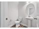 Small bathroom with all white fixtures and wood look floors at 617 Spellbrook Rd, Zebulon, NC 27597
