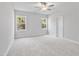Bright, spacious bedroom featuring two windows and plush carpeting at 617 Spellbrook Rd, Zebulon, NC 27597
