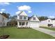 New home featuring a well-manicured lawn, light gray siding, black shutters, and a two car garage at 617 Spellbrook Rd, Zebulon, NC 27597