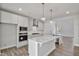 Spacious kitchen featuring gray cabinets, granite countertops, stainless steel appliances, and wood flooring at 617 Spellbrook Rd, Zebulon, NC 27597