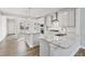 Spacious kitchen featuring gray cabinets, granite countertops, stainless steel appliances, and wood flooring at 617 Spellbrook Rd, Zebulon, NC 27597