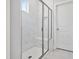 Modern tile shower with glass enclosure and built-in seat at 617 Spellbrook Rd, Zebulon, NC 27597
