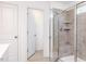 Bathroom featuring a tiled shower with glass door and built-in shelves at 619 Contento Ct, Sanford, NC 27330