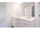 Bathroom features dual sinks, quartz countertop, large mirror, and access to bedroom at 619 Contento Ct, Sanford, NC 27330