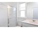 New bathroom features a glass enclosed shower, vanity with quartz countertop, and chrome hardware at 619 Contento Ct, Sanford, NC 27330