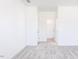 Neutral bedroom with gray carpet leading to more rooms and closets at 619 Contento Ct, Sanford, NC 27330