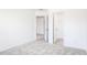 Bright bedroom featuring neutral carpet and an open doorway to a closet at 619 Contento Ct, Sanford, NC 27330