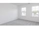 Bedroom with carpet, two windows providing natural light and neighborhood views at 619 Contento Ct, Sanford, NC 27330