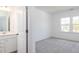 Bright bedroom with neutral carpet, en-suite bathroom, and a window with natural light at 619 Contento Ct, Sanford, NC 27330