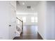 Open entryway with hardwood floors, stairway, and view into the living room filled with natural light at 619 Contento Ct, Sanford, NC 27330