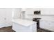 Bright kitchen with stainless appliances and white cabinets offers a large island for food prep and entertaining at 619 Contento Ct, Sanford, NC 27330