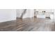 Open-concept living space with hardwood floors that connects to a modern kitchen with stainless appliances and white cabinets at 619 Contento Ct, Sanford, NC 27330