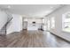 Open-concept living space with hardwood floors and a kitchen with stainless steel appliances and an island at 619 Contento Ct, Sanford, NC 27330