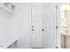 Bright mudroom with white built-in shelves, coat hooks, and an open door to an adjacent bathroom at 619 Contento Ct, Sanford, NC 27330