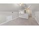 Attic with neutral carpet, closet, and white railing creating a functional and accessible storage space at 6309 Charmco Ct, Wake Forest, NC 27587
