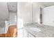 Bathroom featuring a granite countertop and a well lit mirror with hardwood floors at 6309 Charmco Ct, Wake Forest, NC 27587