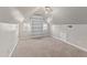 Attic bedroom featuring neutral carpet, built in bookcase and multiple windows for natural light at 6309 Charmco Ct, Wake Forest, NC 27587