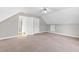 Bright bedroom with soft carpet, ceiling fan, and open doors leading to other areas of the home at 6309 Charmco Ct, Wake Forest, NC 27587