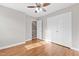 Bedroom features hardwood floors, a ceiling fan, closet, and an open door offering a peek at the stairs at 6309 Charmco Ct, Wake Forest, NC 27587