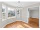 Bright dining area with hardwood floors, a chandelier, and large windows offering ample natural light at 6309 Charmco Ct, Wake Forest, NC 27587