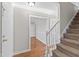 Spacious foyer area featuring hardwood floors, staircase, and easy access to adjacent rooms at 6309 Charmco Ct, Wake Forest, NC 27587