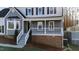 Inviting front porch with white railings and a welcoming entrance, framed by well-kept landscaping at 6309 Charmco Ct, Wake Forest, NC 27587