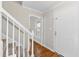 Inviting hallway featuring hardwood floors, a staircase, and a view to the outside at 6309 Charmco Ct, Wake Forest, NC 27587